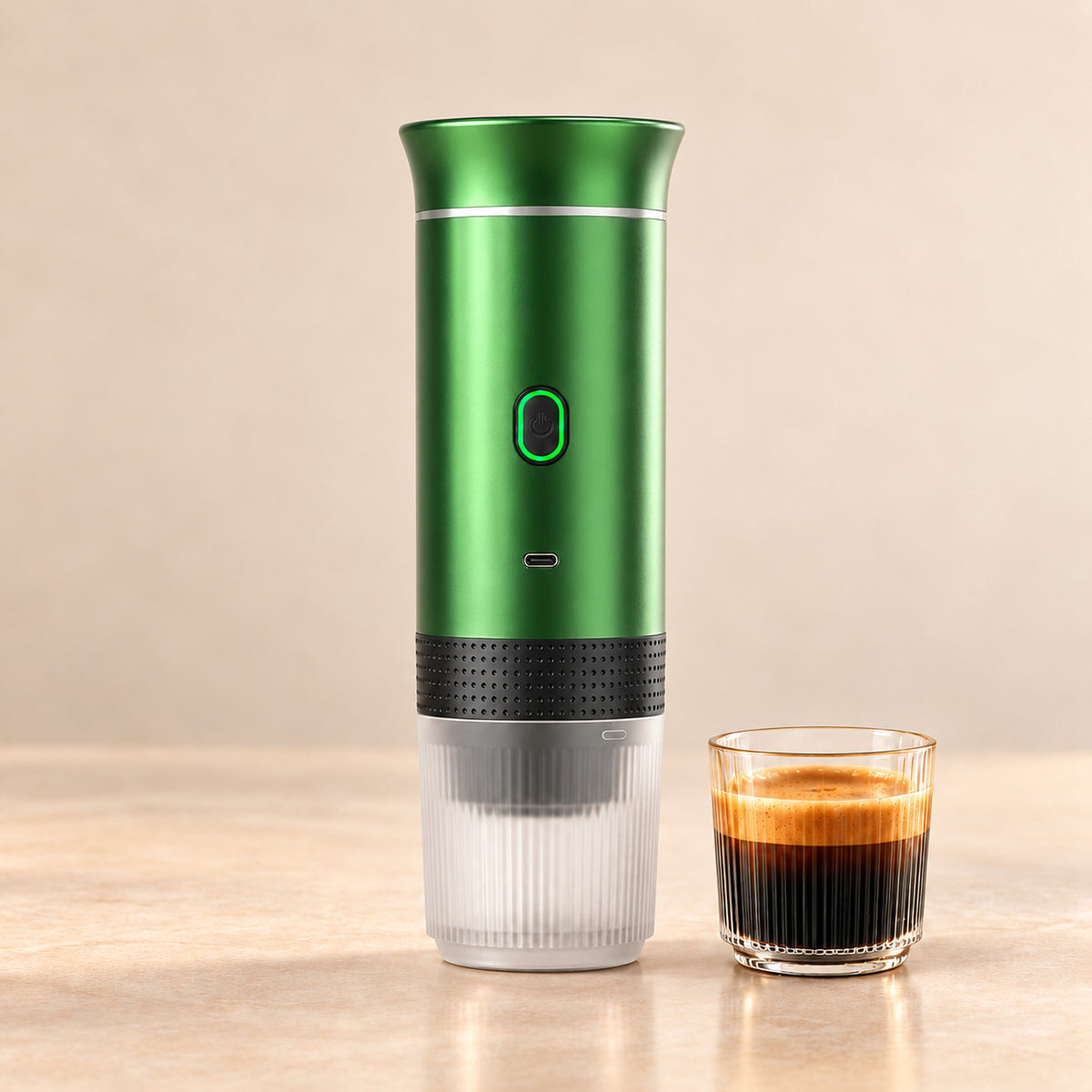Metallic green portable espresso maker with a glass of fresh espresso